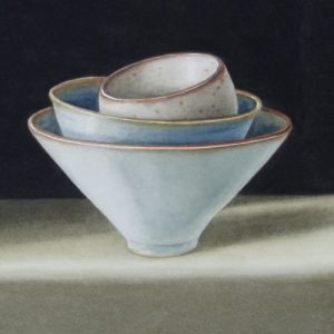 a stack of three bowls with a black background and soft shadows