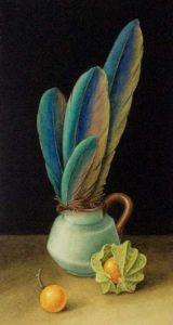 Four blue and gold parrot feathers in a small green jug and a physalis 9 cape gooseberry )fruit in its case